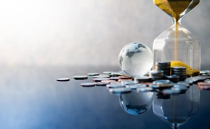 coins next to a jar being filled